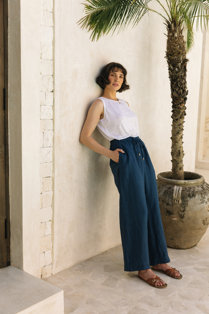 Summery The Label’s navy blue lounge pants made from lightweight linen, styled for relaxed tropical comfort