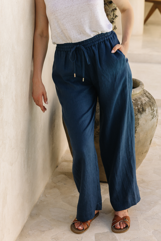 Summery The Label’s navy blue lounge pants made from lightweight linen, styled for relaxed tropical comfort