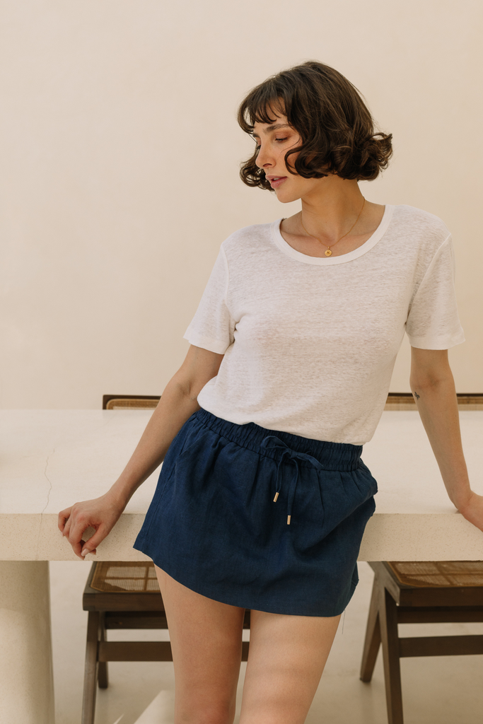 Model wearing a navy blue linen skort from Summery The Label, blending comfort and elegance for tropical days