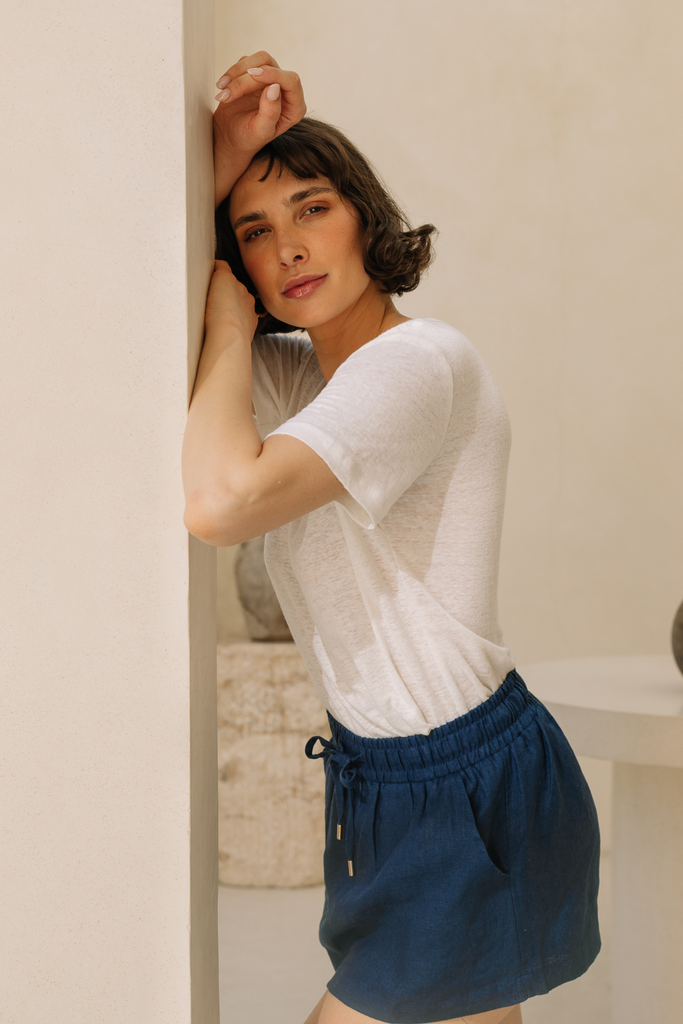 Model wearing a navy blue linen skort from Summery The Label, blending comfort and elegance for tropical days